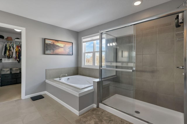 bathroom featuring shower with separate bathtub and tile patterned flooring