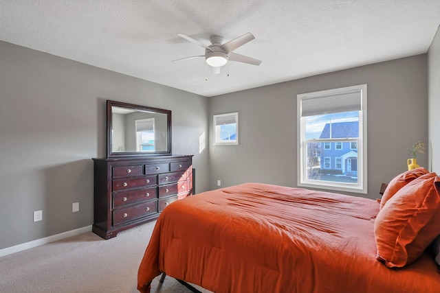 carpeted bedroom with a textured ceiling and ceiling fan