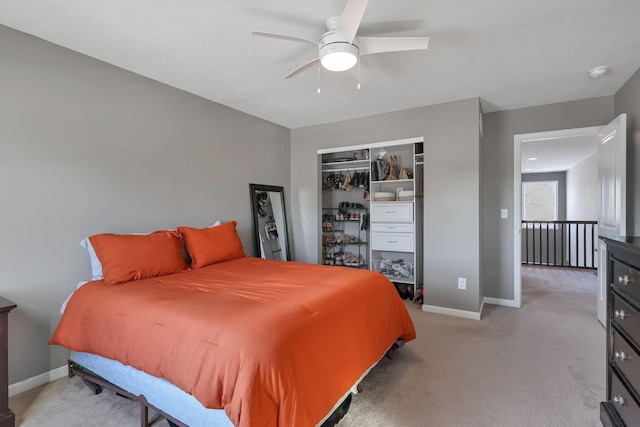 carpeted bedroom featuring ceiling fan and a closet