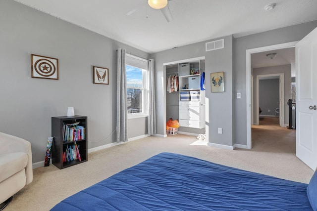 carpeted bedroom with a closet and ceiling fan