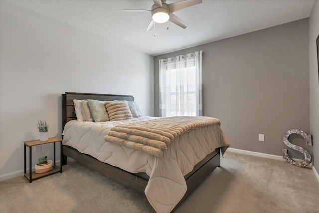 carpeted bedroom featuring a textured ceiling and ceiling fan