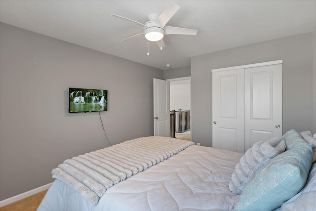 carpeted bedroom with ceiling fan and a closet