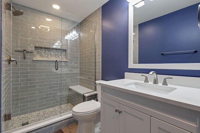 bathroom with vanity, an enclosed shower, wood-type flooring, and toilet