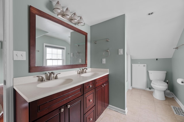 bathroom featuring toilet, visible vents, a sink, and vaulted ceiling