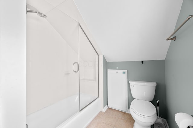 full bathroom with lofted ceiling, tile patterned flooring, and toilet