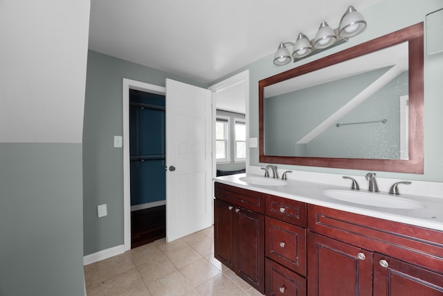 full bathroom with a sink, double vanity, and tile patterned flooring