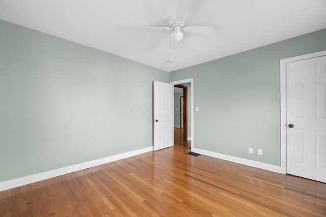 unfurnished bedroom with ceiling fan, light wood-style flooring, baseboards, and visible vents
