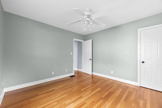 unfurnished bedroom featuring light wood-style floors, baseboards, and ceiling fan