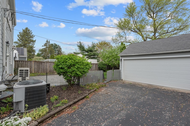 exterior space featuring central AC unit and fence