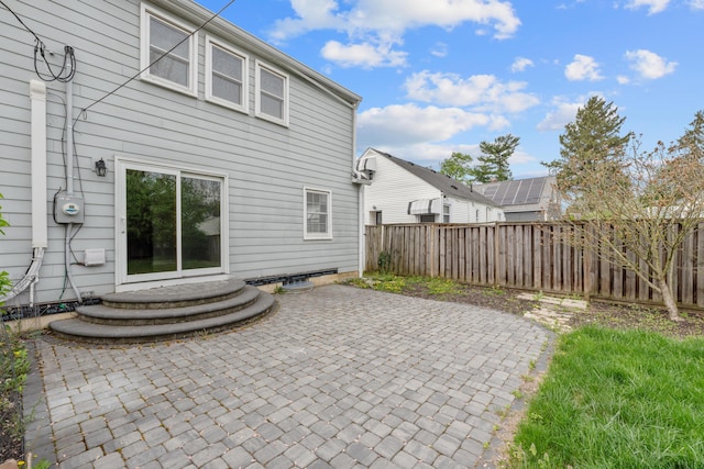 rear view of house with fence and a patio area