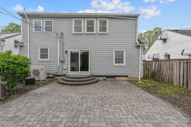 back of house featuring a patio area, a fenced backyard, and ac unit