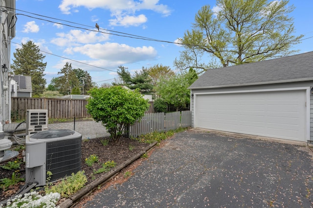 garage featuring cooling unit and fence