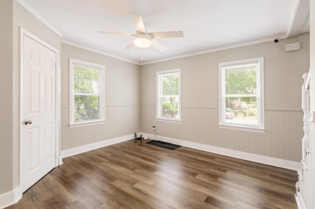 unfurnished room featuring crown molding, dark wood-type flooring, a wealth of natural light, and ceiling fan