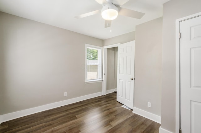 unfurnished bedroom featuring dark wood-type flooring and ceiling fan