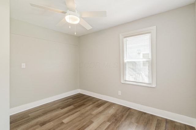 spare room with hardwood / wood-style flooring and ceiling fan