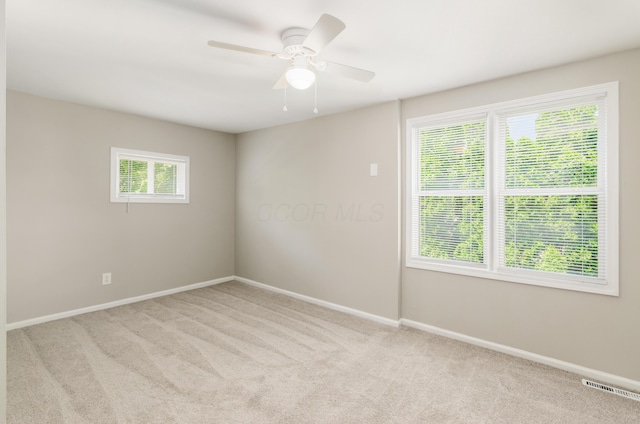 unfurnished room with light carpet and ceiling fan