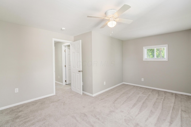 empty room featuring light carpet and ceiling fan