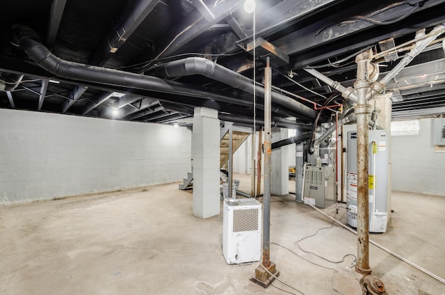 basement featuring heating unit and water heater