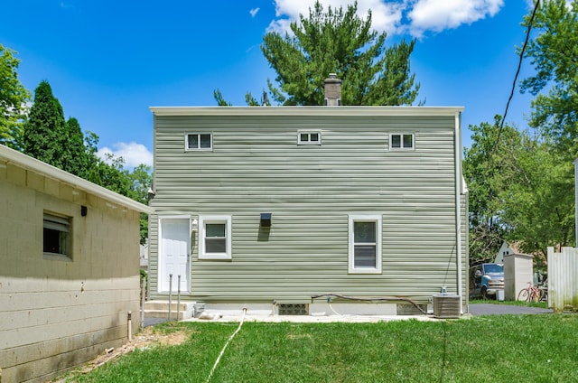 back of property featuring a lawn