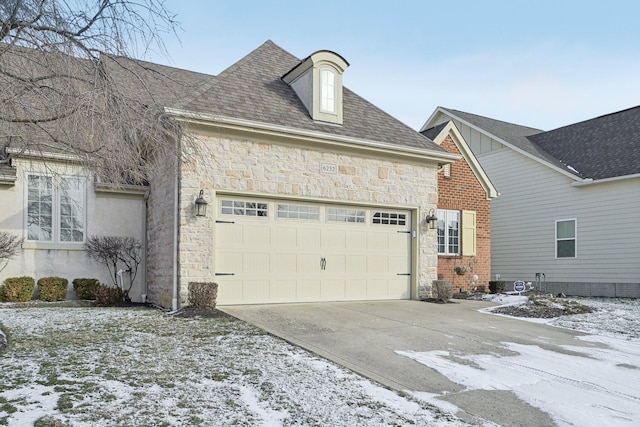 view of snow covered exterior with a garage