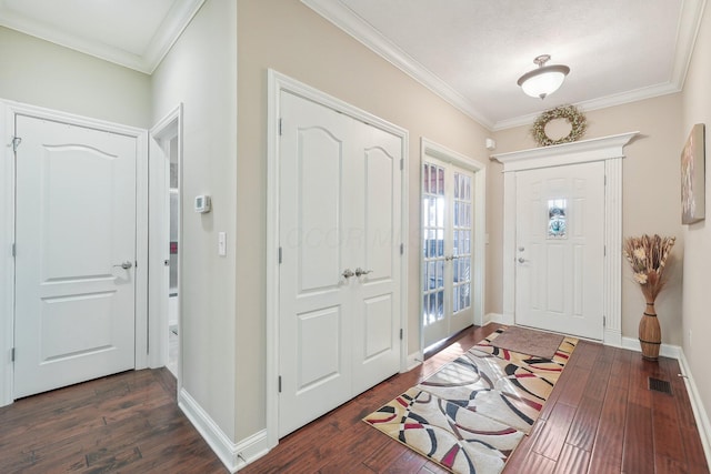 foyer entrance featuring ornamental molding and dark hardwood / wood-style flooring