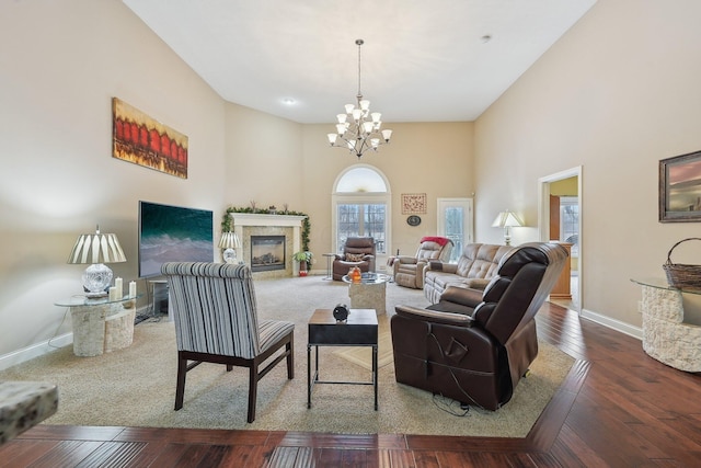 living room featuring a high ceiling, wood-type flooring, and a chandelier