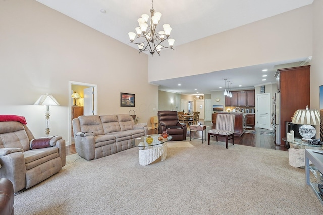 living room featuring a notable chandelier, wood-type flooring, and a high ceiling