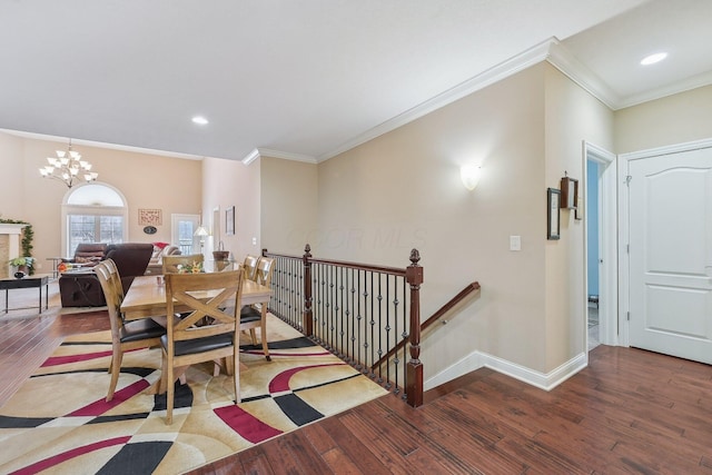 dining area with crown molding, hardwood / wood-style flooring, and a chandelier