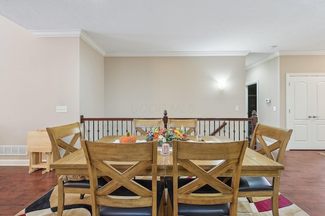 dining room with crown molding and dark hardwood / wood-style flooring