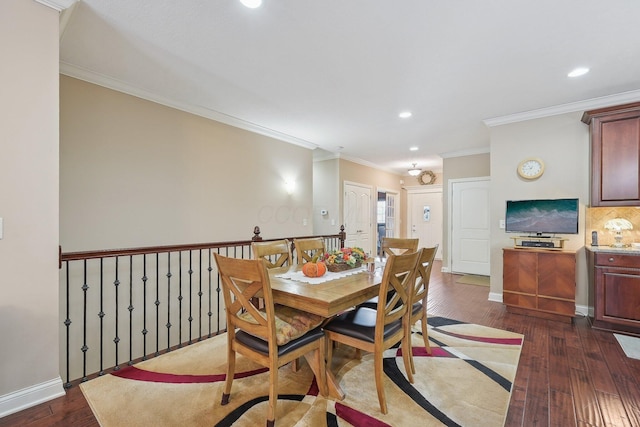 dining area with ornamental molding and dark hardwood / wood-style flooring