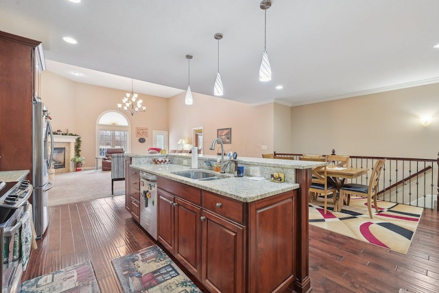 kitchen with sink, decorative light fixtures, a center island with sink, and appliances with stainless steel finishes