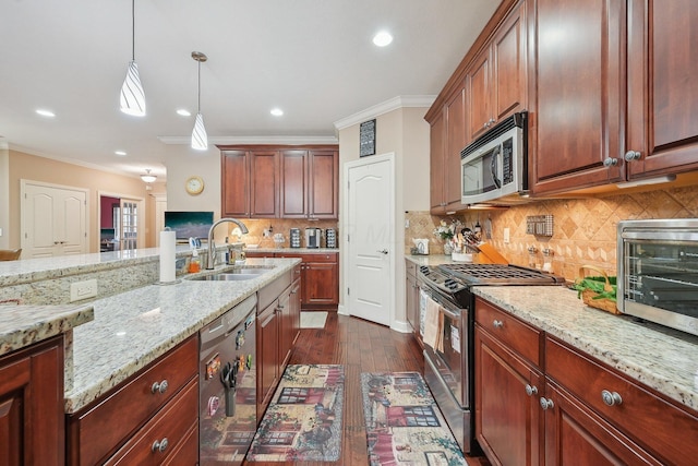 kitchen featuring sink, appliances with stainless steel finishes, hanging light fixtures, light stone counters, and ornamental molding