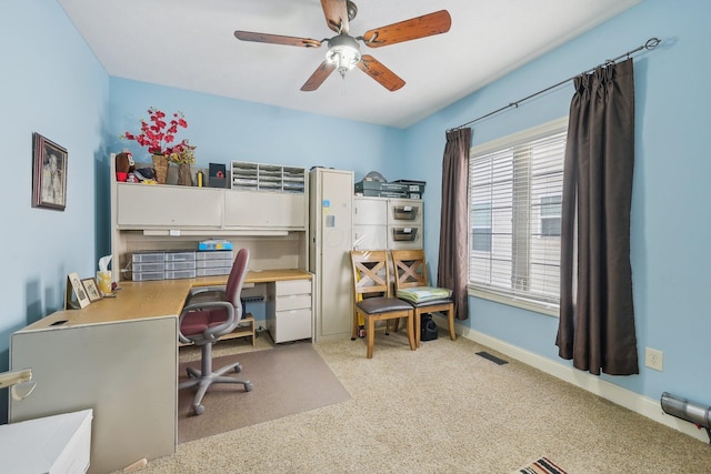 carpeted office featuring ceiling fan