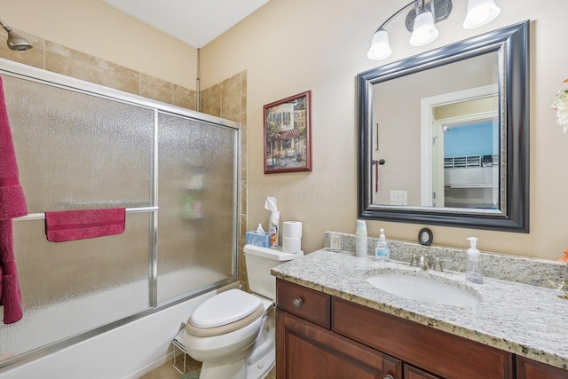 full bathroom featuring shower / bath combination with glass door, vanity, and toilet