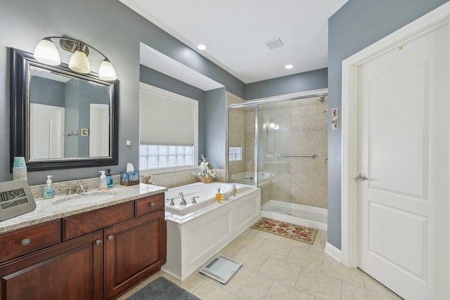 bathroom featuring vanity, shower with separate bathtub, and tile patterned flooring