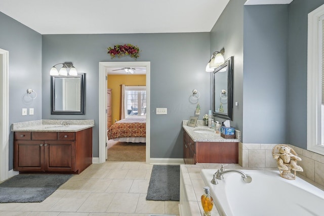 bathroom with vanity, a bathing tub, and tile patterned flooring