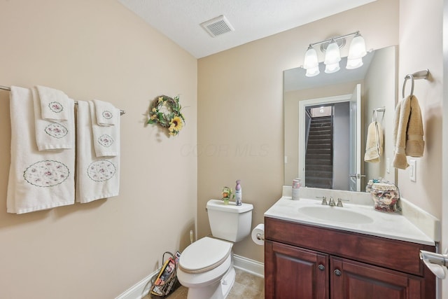 bathroom featuring vanity, toilet, and tile patterned flooring