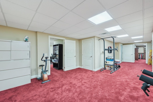 exercise area with carpet and a drop ceiling