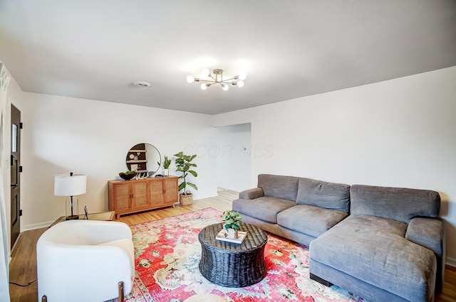 living room featuring a chandelier and hardwood / wood-style floors