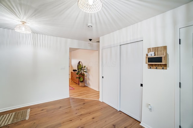 unfurnished bedroom featuring a closet and light hardwood / wood-style flooring