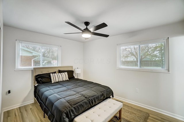 bedroom with light hardwood / wood-style floors and ceiling fan