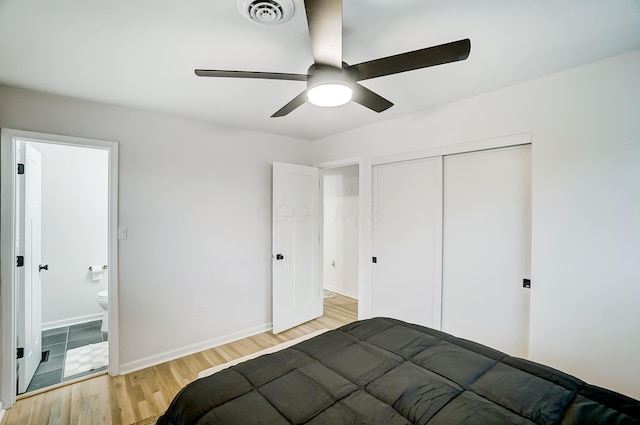 unfurnished bedroom with ceiling fan, a closet, ensuite bath, and light hardwood / wood-style flooring