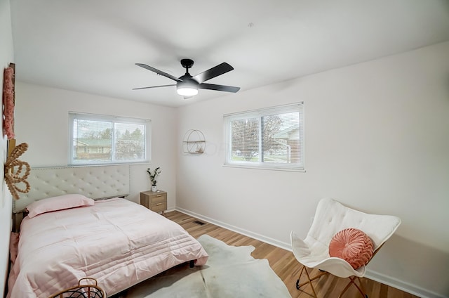 bedroom with ceiling fan and light hardwood / wood-style floors