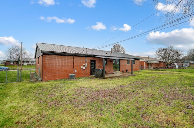 back of property with a yard and a patio area