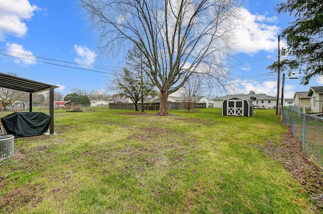 view of yard with central AC unit and a storage unit