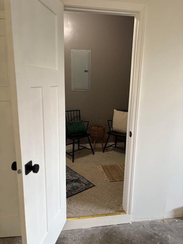 hallway with concrete flooring and electric panel