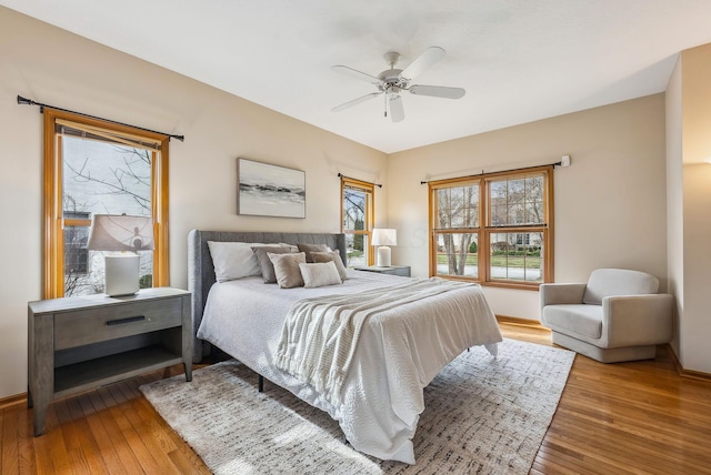 bedroom with wood-type flooring and ceiling fan