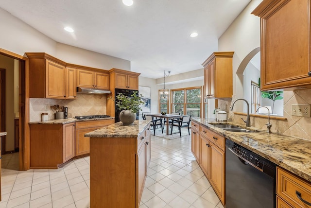 kitchen featuring sink, a center island, black dishwasher, light stone counters, and stainless steel gas cooktop