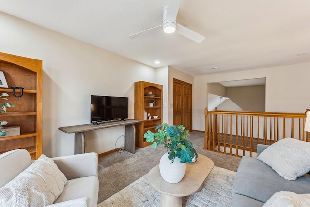 living room with ceiling fan and carpet flooring