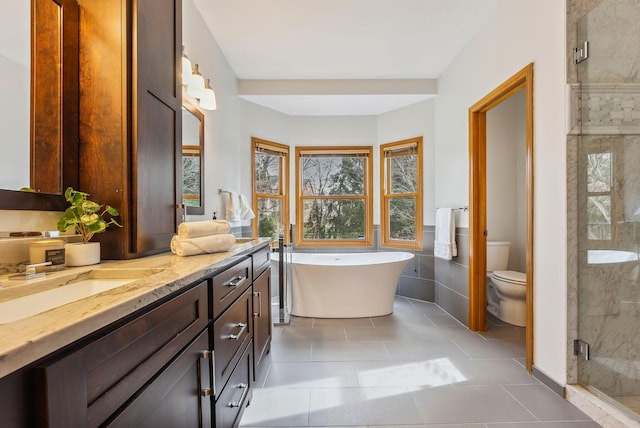 full bathroom featuring vanity, tile patterned floors, toilet, and separate shower and tub